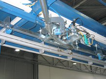 Conveyor to move cable harnesses automatically from one to another workplace